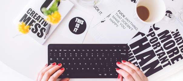 Girl writing on a black keyboard